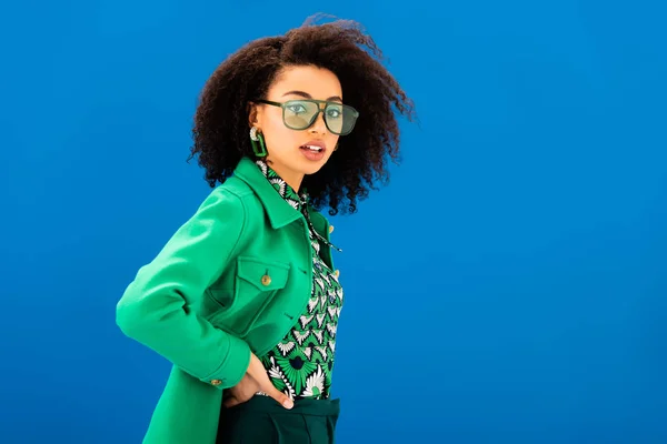 Stylish african american woman looking at camera isolated on blue — Stock Photo