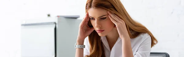 Panoramic shot of pensive businesswoman in hands near head in office — Stock Photo