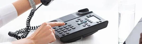 Cropped view of businesswoman using phone at table, panoramic shot — Stock Photo