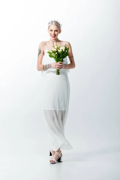 Happy beautiful tattooed bride with bouquet on white — Stock Photo