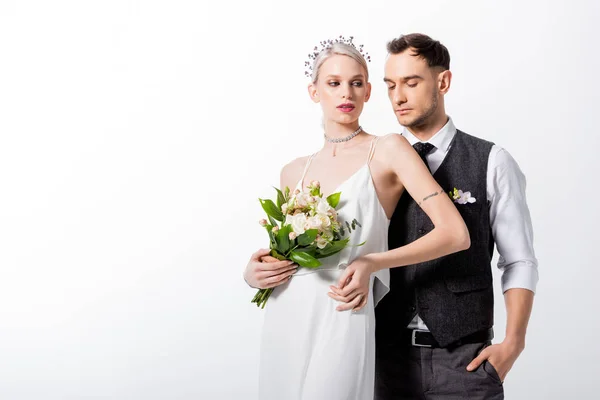 Beautiful tattooed bride and handsome bridegroom isolated on white — Stock Photo