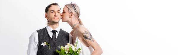 Beautiful tattooed bride kissing handsome bridegroom isolated on white, panoramic shot — Stock Photo