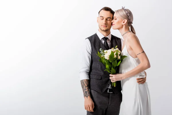 Beautiful tattooed bride and handsome bridegroom with closed eyes isolated on white — Stock Photo