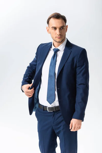 Successful young businessman in blue suit isolated on white — Stock Photo