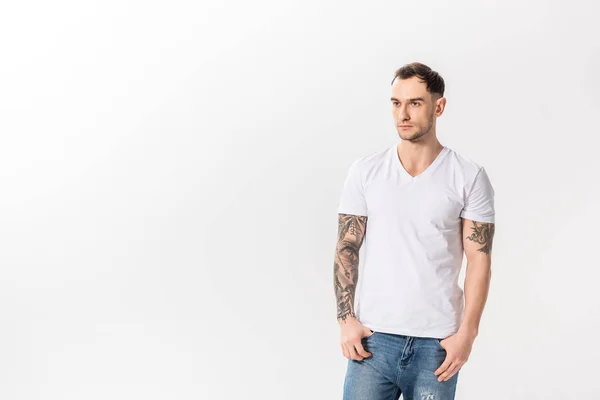 Красивий молодий татуйований чоловік в джинсах позує ізольовано на білому — стокове фото