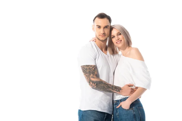 Young tattooed couple embracing isolated on white — Stock Photo