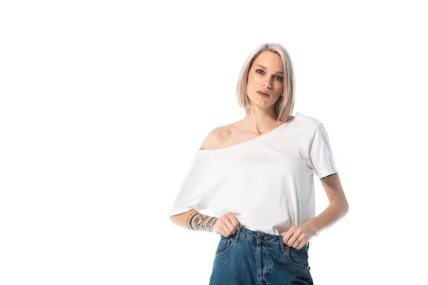 Young tattooed girl in jeans isolated on white — Stock Photo