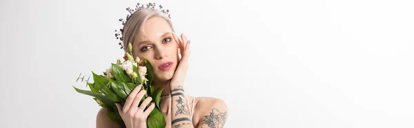 Portrait of beautiful tattooed bride posing with floral bouquet on white, panoramic shot — Stock Photo