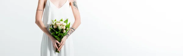 Cropped view of tattooed bride with floral bouquet on white, panoramic shot — Stock Photo