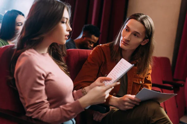 Handsome actor and beautiful actress reading scripts in theatre — Stock Photo