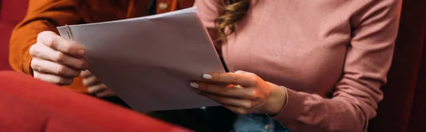 Panoramic shot of actor and actress reading screenplay in theatre — Stock Photo