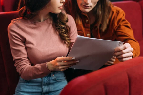 Cropped view of young actor and actress reading screenplay in theatre — Stock Photo