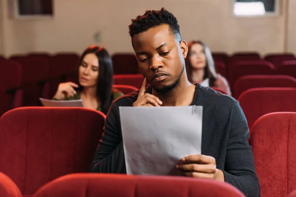 Young actor and actresses reading scripts in theater — Stock Photo