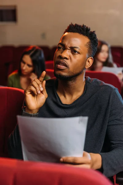 Multicultural young actor and actresses reading scripts in theater — Stock Photo