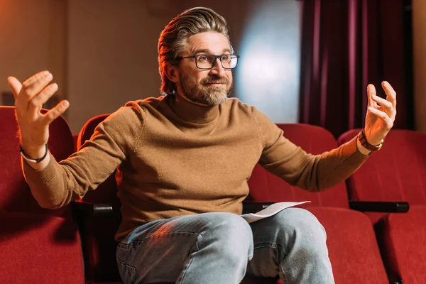 Emotional mature stage director with scenario in theater — Stock Photo