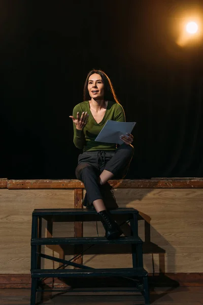 Beautiful actress performing role with screenplay on stage in theatre — Stock Photo