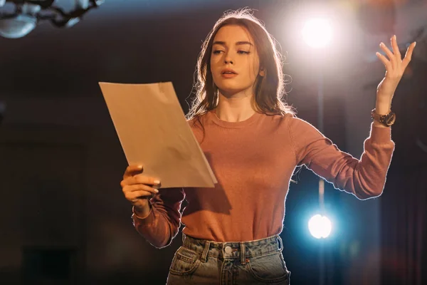 Young actress reading scenario on stage in theatre — Stock Photo