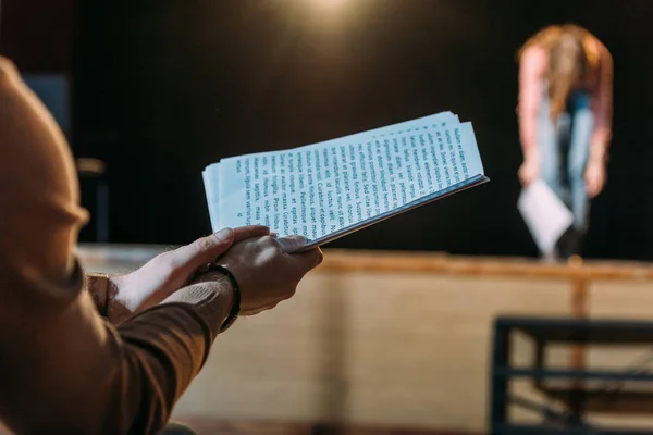 Selective focus of theater director with scenario applauding to actress bowing on stage — Stock Photo