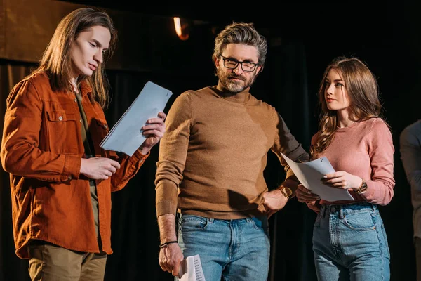 Young actor and actress on rehearse with mature theater director — Stock Photo