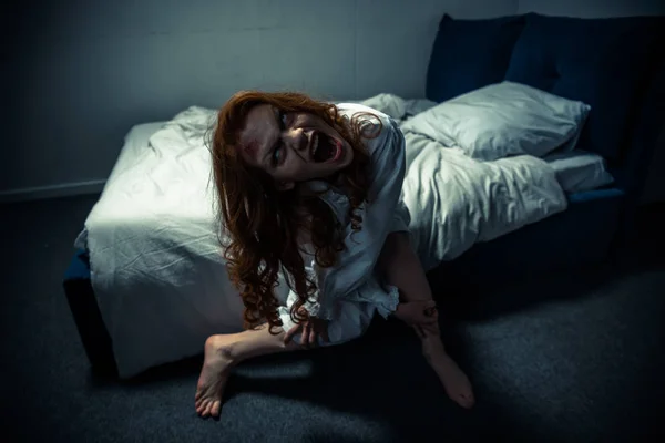 Demonic woman in nightgown screaming in bedroom — Stock Photo