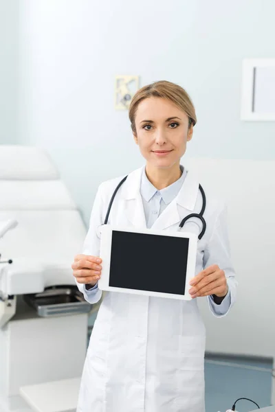 Professional gynecologist holding digital tablet with blank screen in clinic — Stock Photo