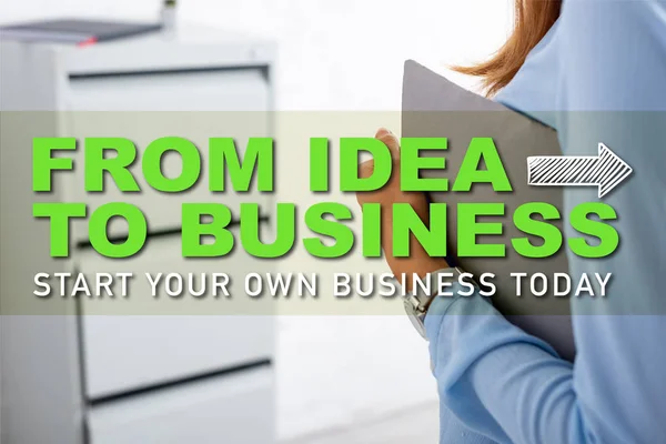 Cropped view of businesswoman holding paper folder in office, from idea to business illustration — Stock Photo