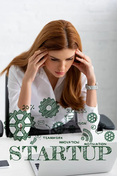 Pensive businesswoman with hands near head looking at laptop on table, startup illustration — Stock Photo