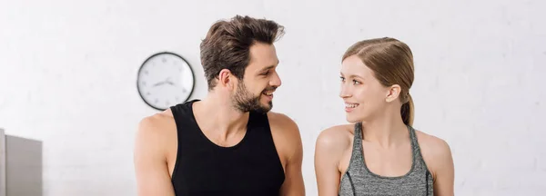 Panoramic shot of happy man and cheerful woman looking at each other — Stock Photo