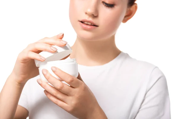 Bela adolescente com pele perfeita segurando recipiente de plástico com creme cosmético, isolado em branco — Fotografia de Stock