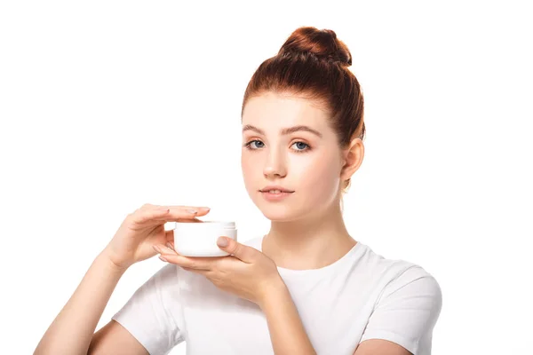 Bela adolescente com pele perfeita segurando recipiente de plástico com creme cosmético, isolado em branco — Fotografia de Stock