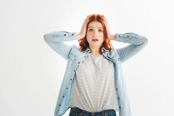 Shocked redhead teen girl in denim clothes, isolated on white — Stock Photo