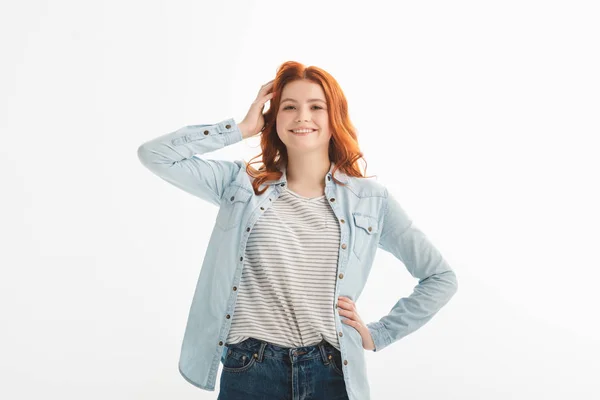 Красивая улыбающаяся рыжая девушка-подросток в джинсовой одежде, изолированная на белом — стоковое фото