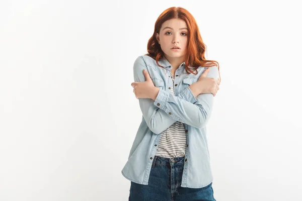 Sad redhead female teenager cold in denim clothes, isolated on white — Stock Photo