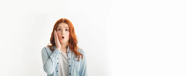 Panoramic shot of beautiful surprised female teenager gesturing in denim clothes, isolated on white — Stock Photo