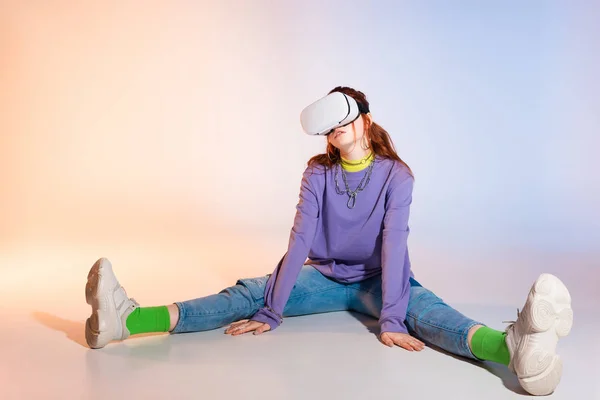 Bored teen girl using vr headset, on purple and beige — Stock Photo