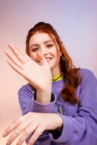 Beautiful smiling redhead teen girl, on purple and beige — Stock Photo