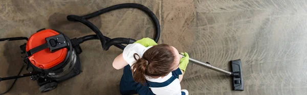 Top view of cleaner vacuuming floor, panoramic shot — Stock Photo