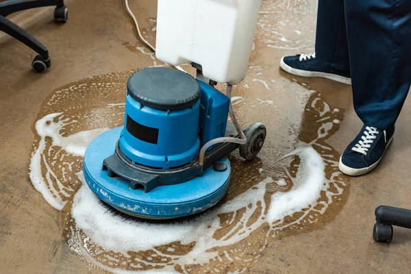 Vista recortada del piso de lavado más limpio con la máquina de limpieza - foto de stock