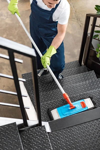 High angle view of young cleaner washing stairs with mop — Stock Photo