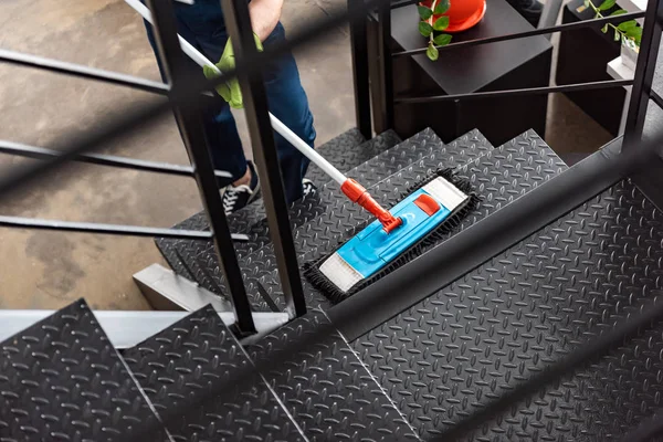 Cropped view of cleaner washing stairs with mop — Stock Photo