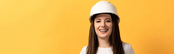 Panoramic shot of smiling handywoman looking at camera isolated on yellow — Stock Photo