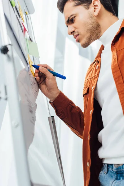 Low angle view of ux developer planning app interface on whiteboard in office — Stock Photo