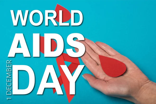 Top view of paper drop of blood on female hand on blue background, world aids day illustration — Stock Photo