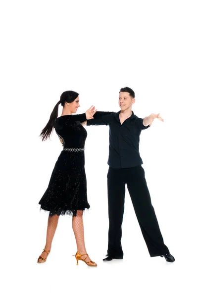 Elegant young couple of ballroom dancers in black dress and suit dancing isolated on white — Stock Photo