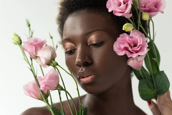 Tender naked african american girl with pink flowers isolated on white — Stock Photo