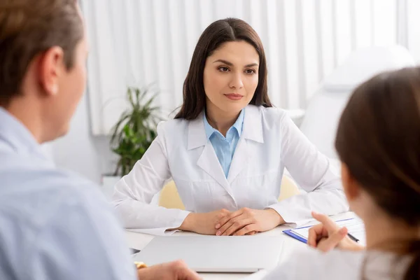 Cropped view of father and daughter near smiling ent physician in clinic — Stock Photo