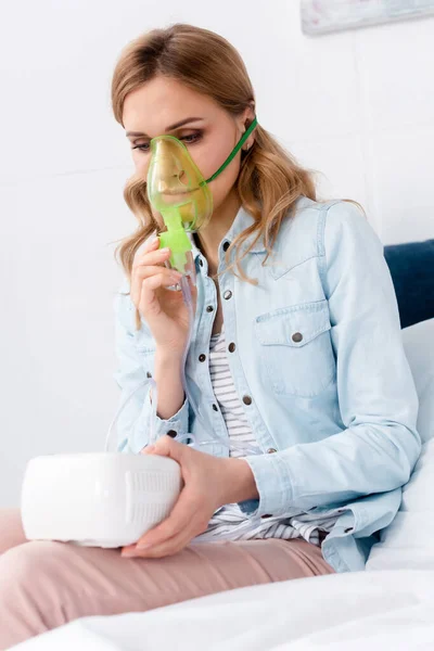Asthmatic woman in respiratory mask using compressor inhaler — Stock Photo