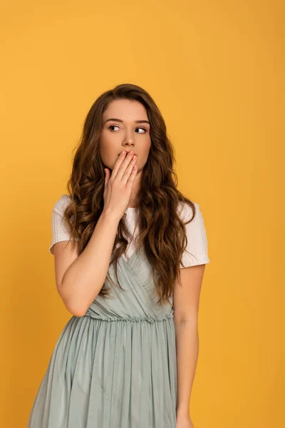 Attractive shocked spring woman isolated on yellow — Stock Photo
