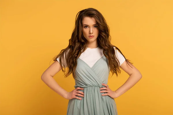 Confident spring woman with long hair isolated on yellow — Stock Photo