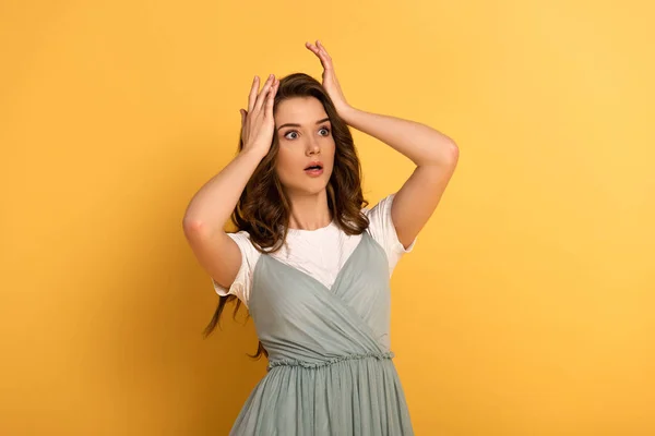 Shocked spring girl in t-shirt and dress on yellow — Stock Photo